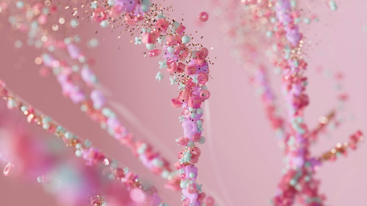 Abstract 3D illustration of intertwined strands composed of glossy pink, purple, cyan, and gold particles, resembling DNA or neural pathways, set against a soft pink background.