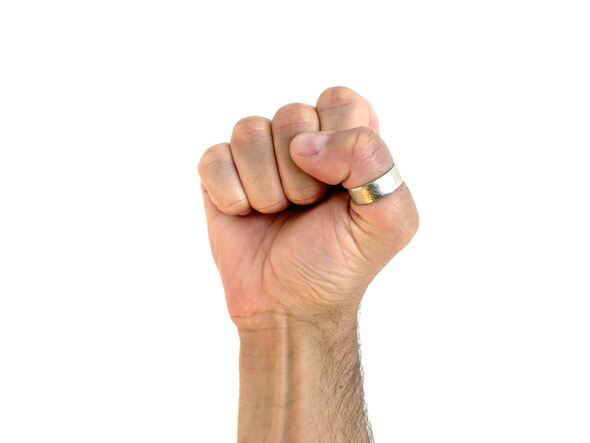 A raised fist with a silver ring on the thumb, centered against a white background, symbolizing unity, strength, or grassroots empowerment.